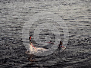 A man is learning flysurfing under the supervision of an instructor.