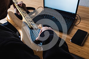 Man is learning how to play the guitar