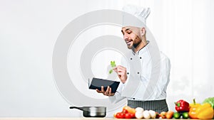 Man Learning To Cook Reading Recipe Book In Kitchen, Panorama