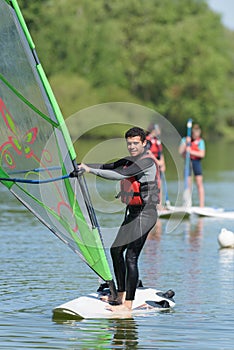 Man learning to do windsurfing