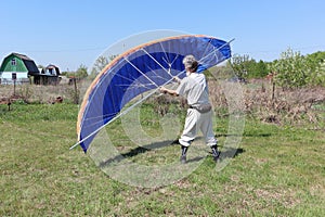 Man learns to manage homemade kitewing on the lawn
