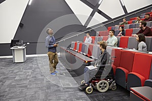 Man lecturing students in a university lecture theatre