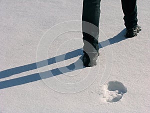Man legs and footprints on the snow photo