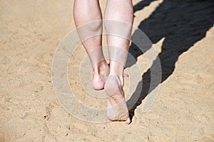 Man legs on sand. Male feet walking on beautiful sandy beach of hotel resort in Egypt, doing and leave footprints in sand.