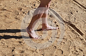 Man legs on sand. Male feet walking on beautiful sandy beach of hotel resort in Egypt, doing and leave footprints in sand.