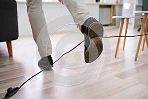 Man Legs Stumbling With An Electrical Cord