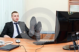 Man with legs on table in office