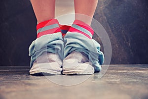 Man legs with their pants down in the toilet room, close-up. Concept of problems with diarrhea and stomach pain, copy space