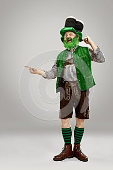 A man in a leprechaun hat at studio. He celebrates St. Patrick`s Day.