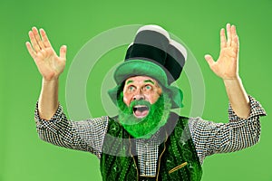 A man in a leprechaun hat at studio. He celebrates St. Patrick`s Day.