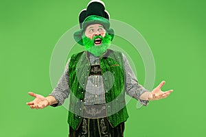 A man in a leprechaun hat at studio. He celebrates St. Patrick`s Day.