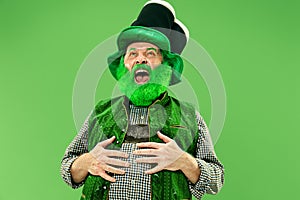 A man in a leprechaun hat at studio. He celebrates St. Patrick`s Day.