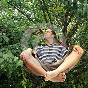 Man levitating in garden