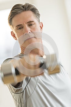 Man Lifting Dumbbell At Gym