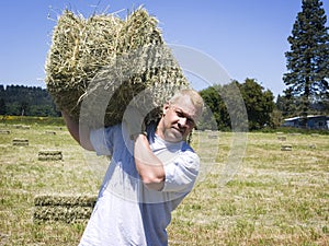 Man lifting hay bale