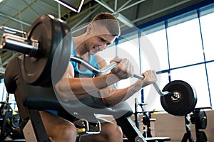 Man Lifting Heavy Barbell with Effort