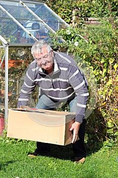 Man lifting heavy box correctly.