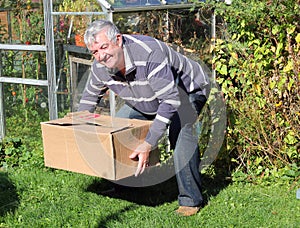 Man lifting heavy box correctly.