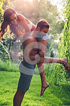 Man lifting his girl up while she is struggling