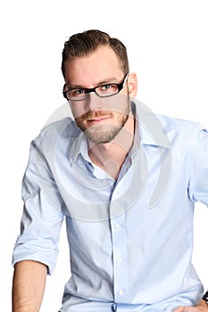 Man in light blue shirt and jeans sitting down