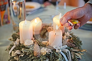 Man lighting candles of Advent wreath photo