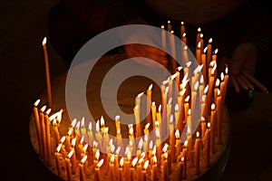 Man lighting candles in a church