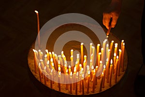 Man lighting candles in a church