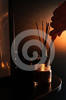 Man lights a candle. the concept of a cozy home relaxing atmosphere. relaxation and aromatherapy