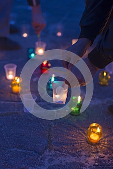 A man lights a candle. Day of Remembrance for the Bereaved