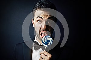 Man liking a lollipop