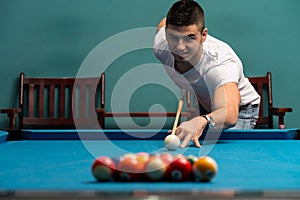 Man Lining Ball Up To Break In Pool