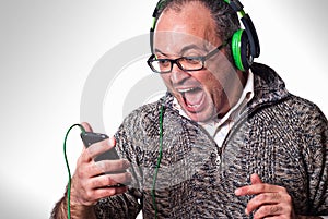 Man listen music on headphones and scream aloud