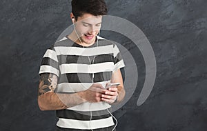 Man listen to music in earphones, studio shot