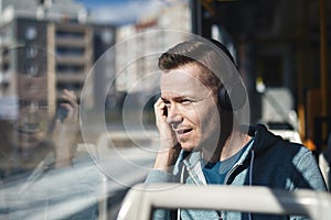 Man listening music while commuting by public transportation