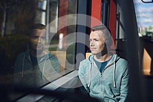 Man listening music while commuting by public transportation