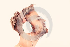 Man listening music headphones white background. Modern technology. Music taste concept. Enjoy perfect music sound