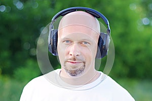 Man listening music outdoors in wireless headset