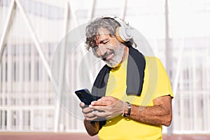 man listening music from phone with headphones