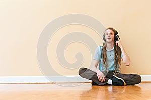 Man listening to headphones in a big room