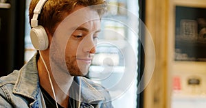 Man listening to music on digital tablet