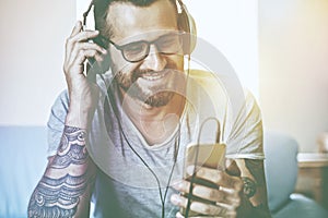 Man listening to music with headphones and smart phone