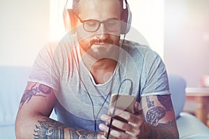 Man listening to music with headphones and smartphone