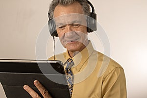 Man listening to music on his smart tablet