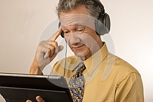 Man listening to music on his smart tablet