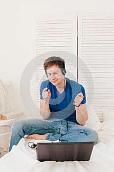 Man listening to music at a laptop