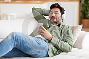 Man Listening to Music on Phone on Couch