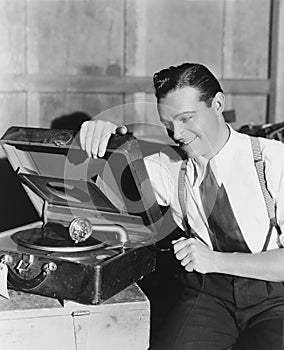 Man listening to record player