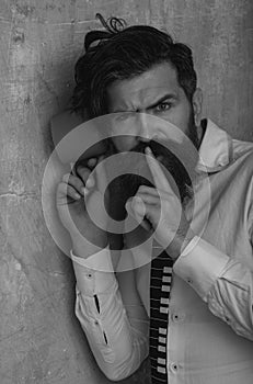 Man listening through the wall with the cup. Secrets and gossip concept. Curious guy overhearing neighbors.