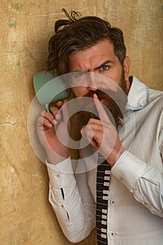 Man listening through the wall with the cup. Secrets and gossip concept. Curious guy overhearing neighbors.