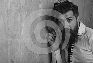 Man listening through the wall with the cup. Secrets and gossip concept. Neighbour and secret. Funny man with beard hear